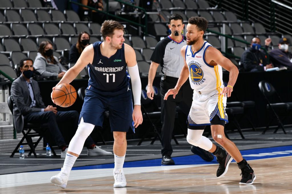 Steph Curry guards Luka Doncic